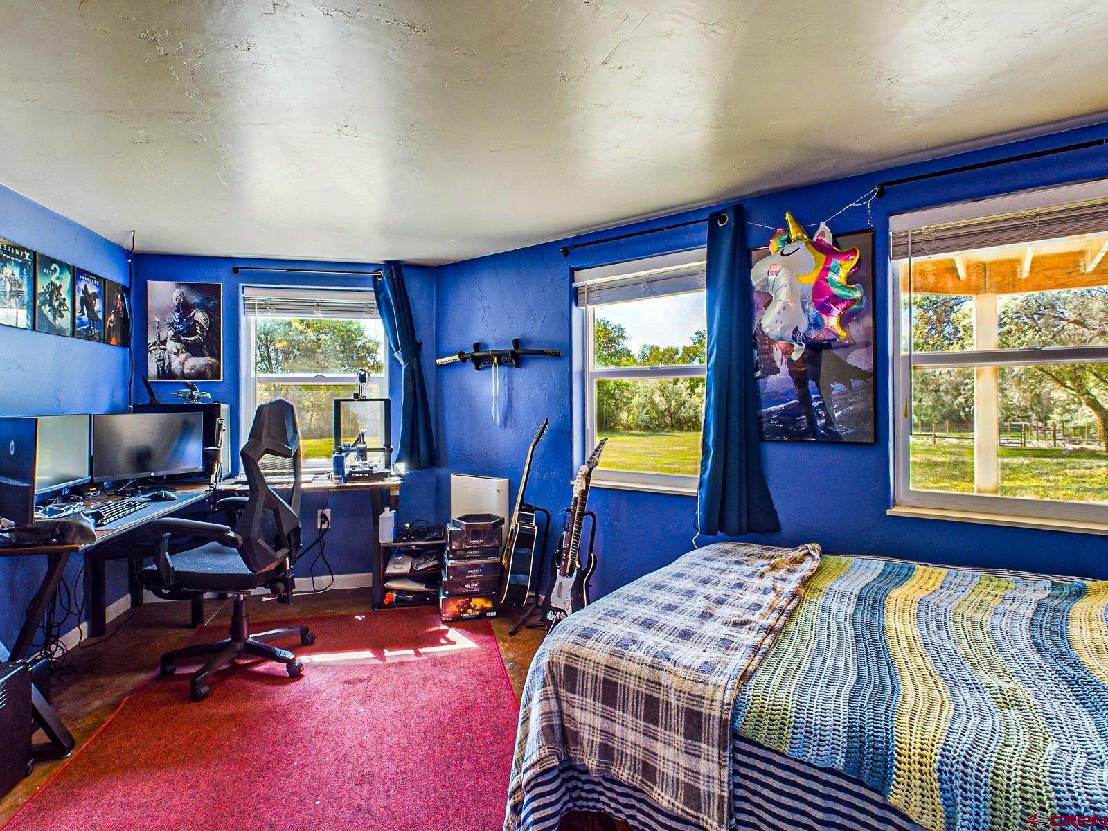 20260 Fawn Circle Eckert, CO 81418 - Photo 23 of 35 a bedroom with a bed and a table