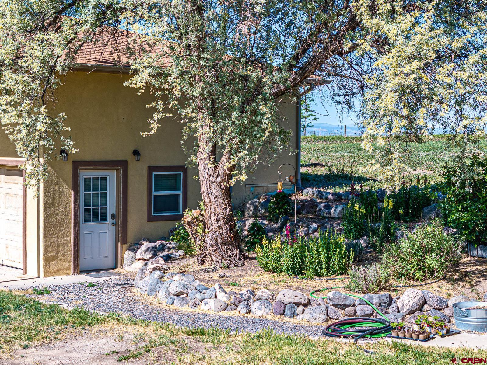 20260 Fawn Circle Eckert, CO 81418 - Photo 32 of 35 a front view of a house with garden