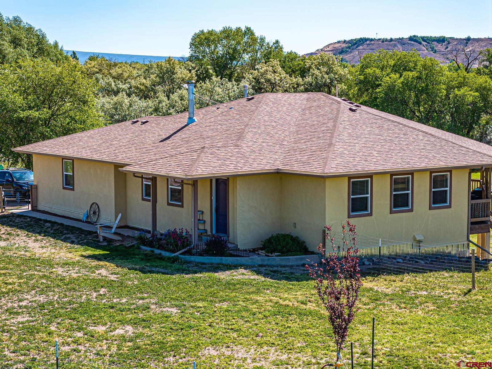 20260 Fawn Circle Eckert, CO 81418 - Photo 4 of 35 a view of a house with swimming pool and a yard chairs under an umbrella