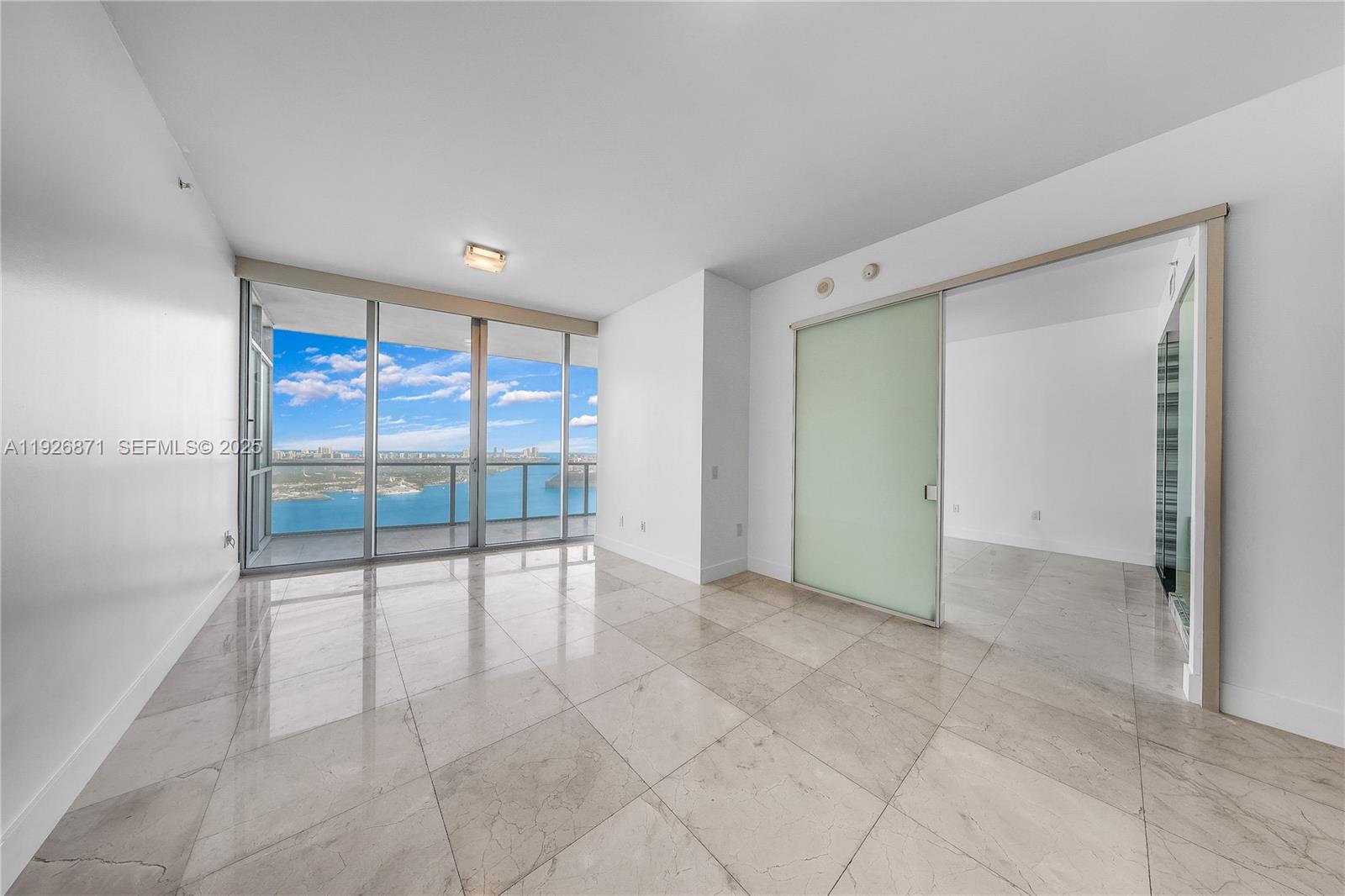 1100 Biscayne Boulevard, Unit 3103 Miami, FL 33132 - Photo 11 of 28 a view of an empty room with a sliding door