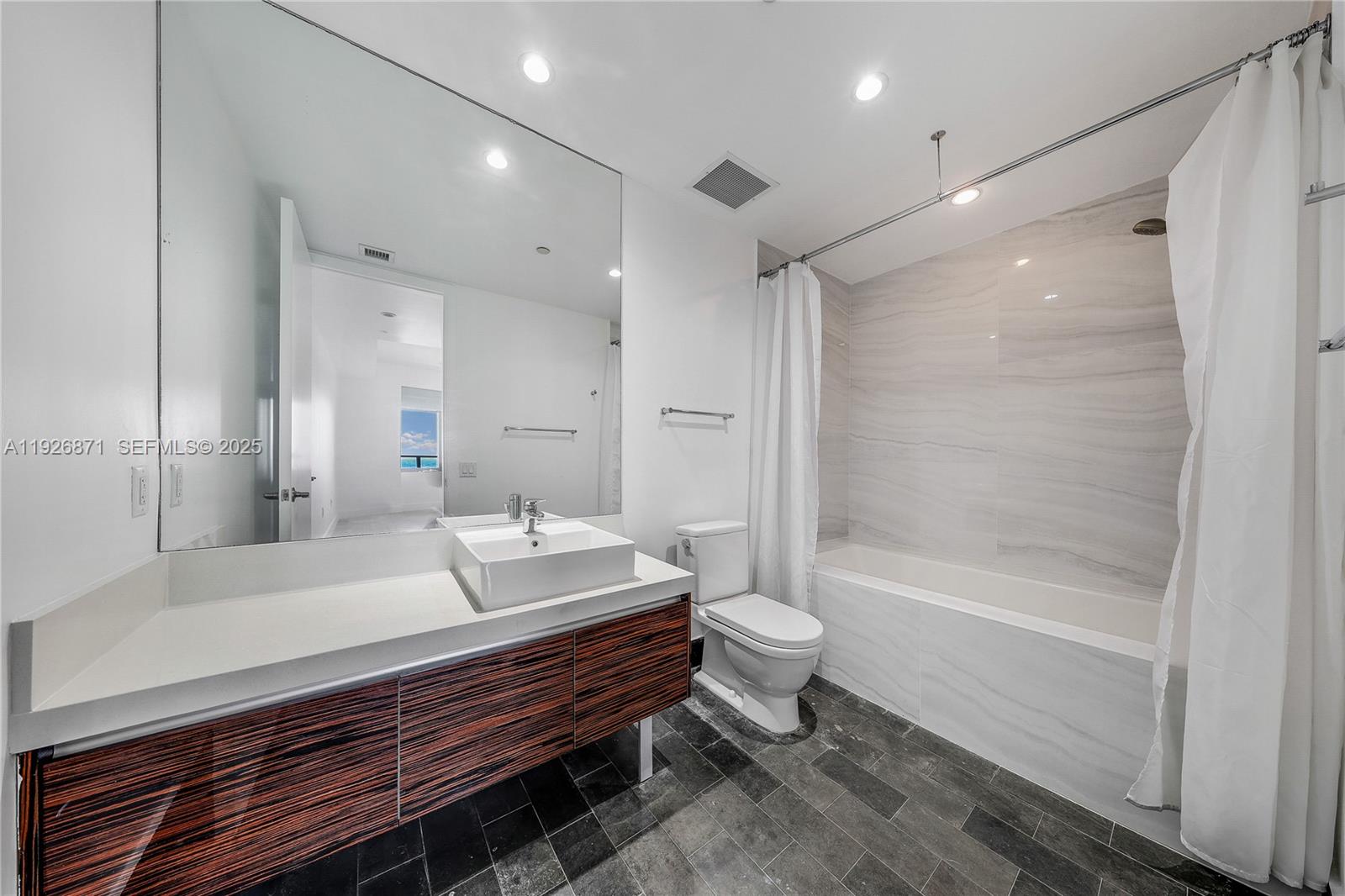 1100 Biscayne Boulevard, Unit 3103 Miami, FL 33132 - Photo 12 of 28 a bathroom with a bathtub shower sink and toilet
