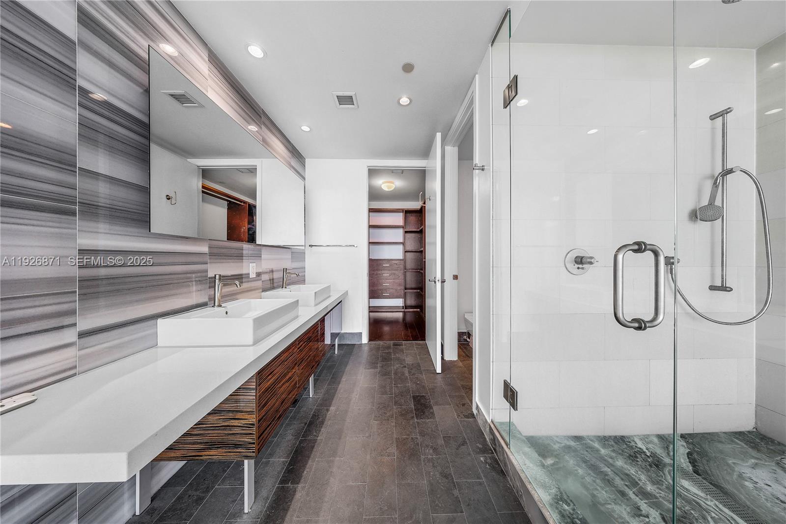 1100 Biscayne Boulevard, Unit 3103 Miami, FL 33132 - Photo 15 of 28 a bathroom with a sink a double vanity and a shower