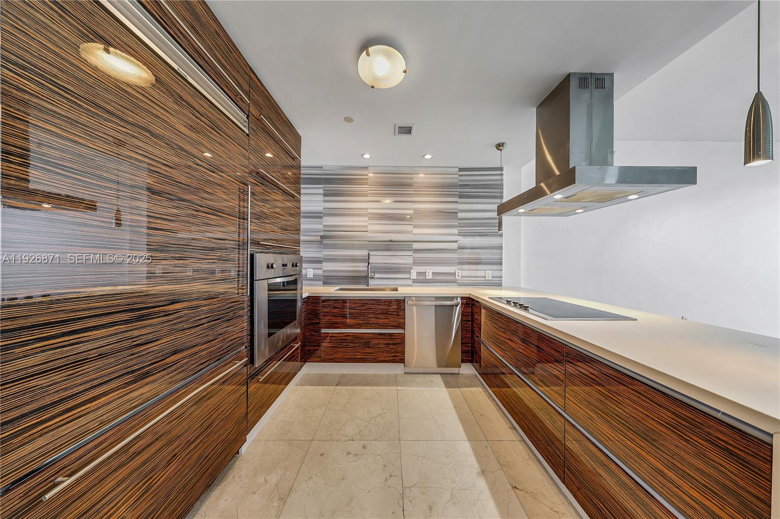 1100 Biscayne Boulevard, Unit 3103 Miami, FL 33132 - Photo 5 of 28 a kitchen with granite countertop a sink and cabinets