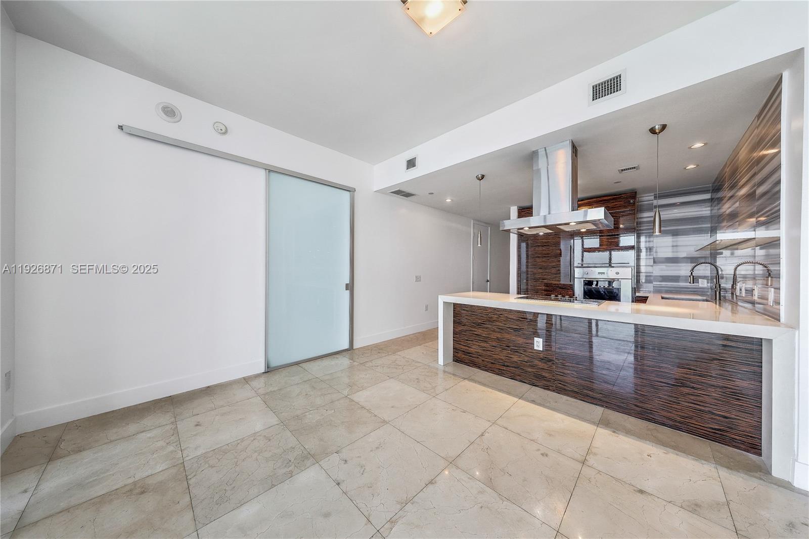 1100 Biscayne Boulevard, Unit 3103 Miami, FL 33132 - Photo 9 of 28 a view of kitchen with cabinets