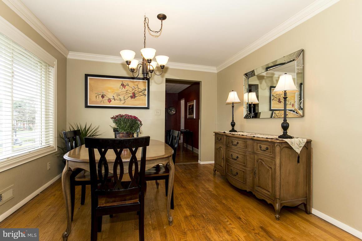 4012 Kahlston Road Baltimore, MD 21236 - Photo 11 of 30 a view of a dining room with furniture wooden floor and a chandelier