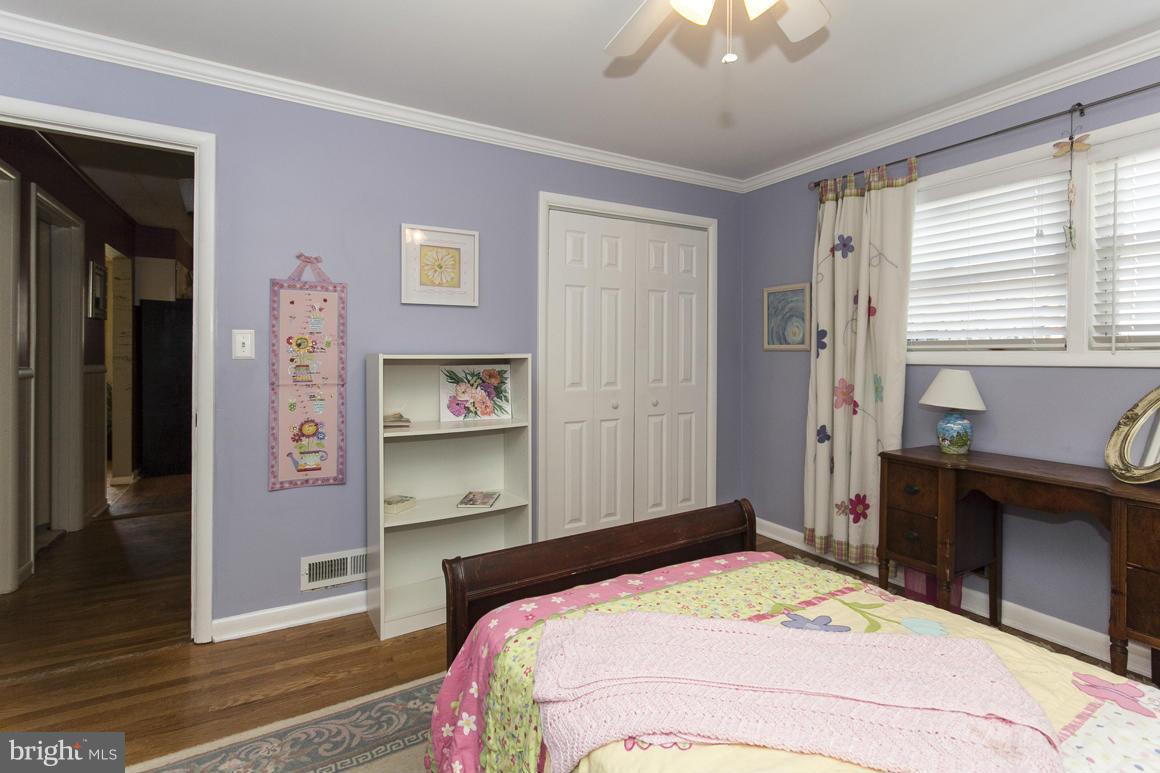 4012 Kahlston Road Baltimore, MD 21236 - Photo 21 of 30 a bedroom with a bed and a chandelier