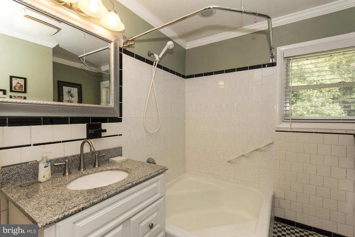 4012 Kahlston Road Baltimore, MD 21236 - Photo 22 of 30 a bathroom with a granite countertop sink and a mirror