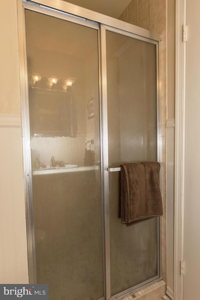 4012 Kahlston Road Baltimore, MD 21236 - Photo 24 of 30 a bathroom with a glass shower door