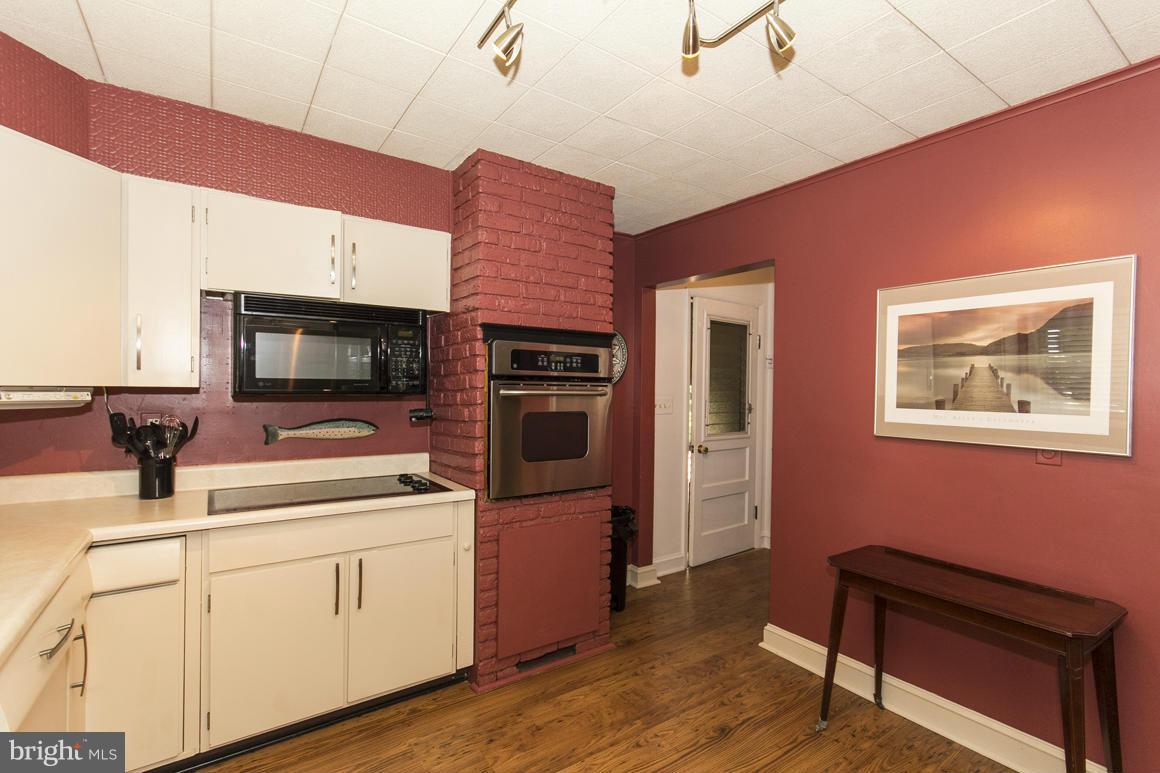 4012 Kahlston Road Baltimore, MD 21236 - Photo 8 of 30 a kitchen with a sink cabinets and wooden floor