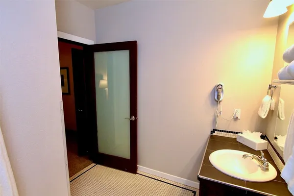 a bathroom with a sink mirror and vanity