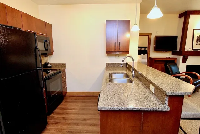 a kitchen with a sink microwave and refrigerator