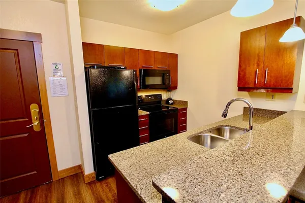 a kitchen with a refrigerator and a sink
