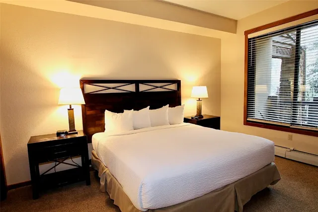 a bedroom with a bed and a night stand