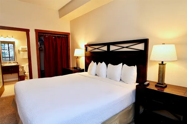 a bedroom with a bed and a night stand