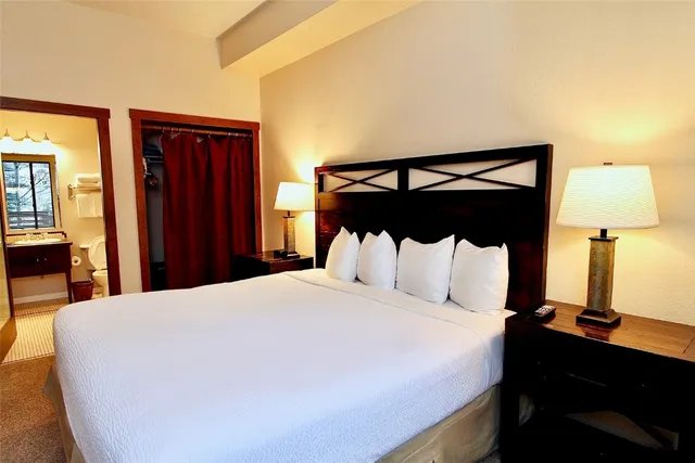 a bedroom with a bed and a night stand