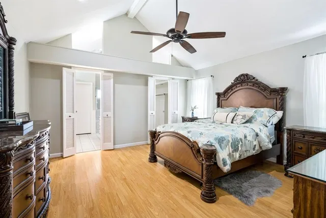 a bedroom with a bed and ceiling fan