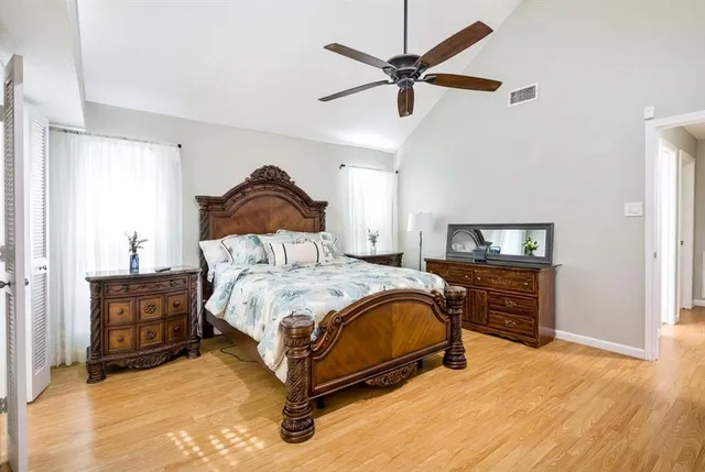 a bedroom with a bed dresser and a tv