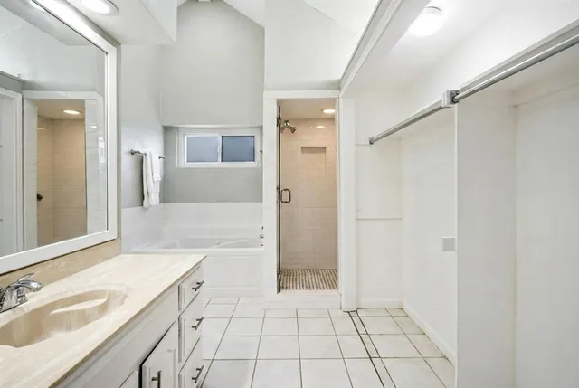 a bathroom with a sink a mirror and a shower