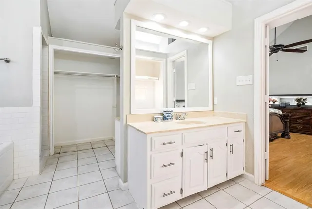 a spacious bathroom with a sink a mirror and a shower