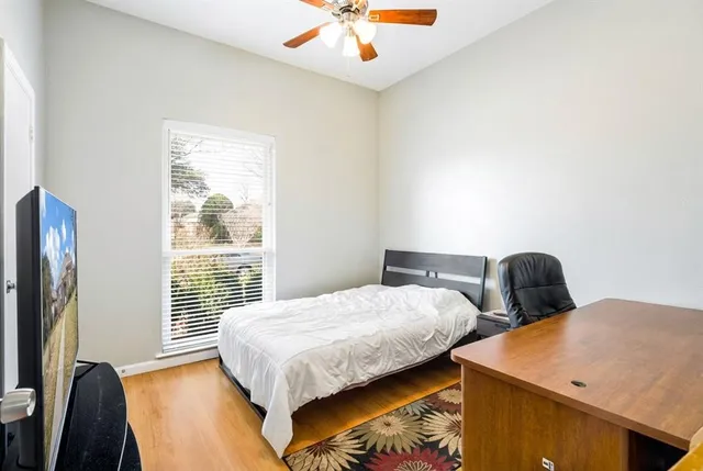 a bedroom with two beds and a chandelier