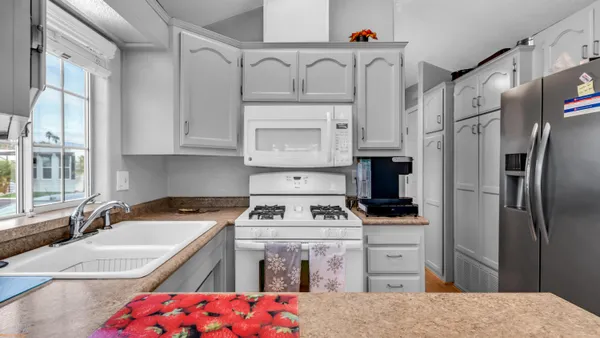 a kitchen with a sink stove and refrigerator