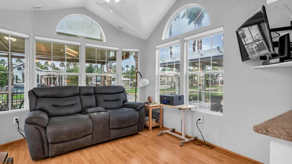a view of a house with a yard and a palm tree