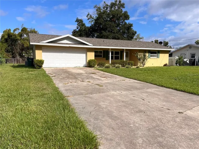 a front view of a house with a garden and yard
