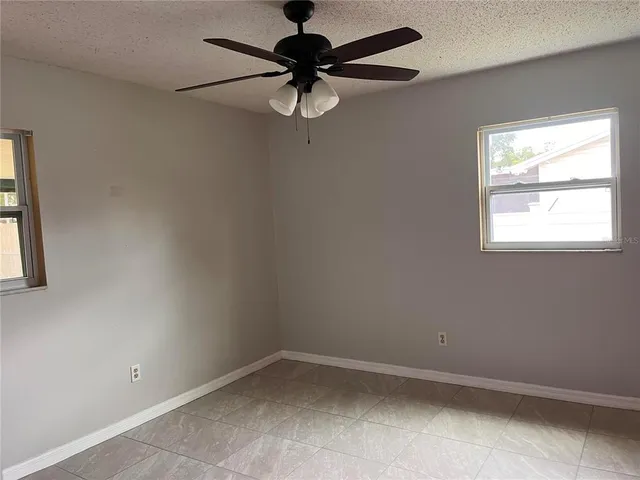 an empty room with windows and closet