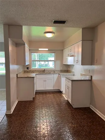 a kitchen with cabinets and a window