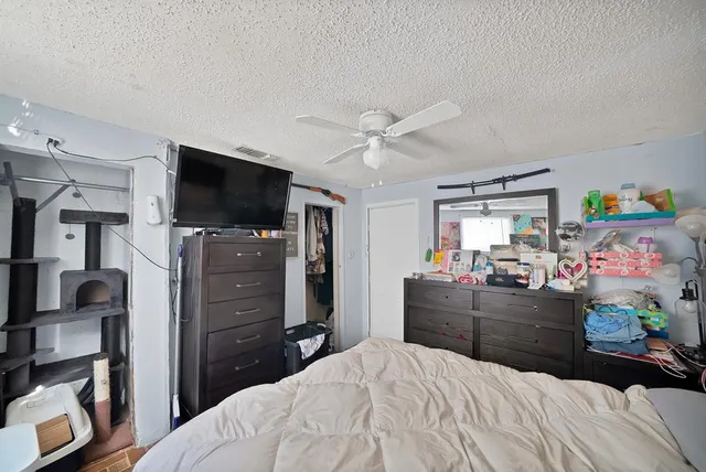 a bedroom with a bed and flat screen tv