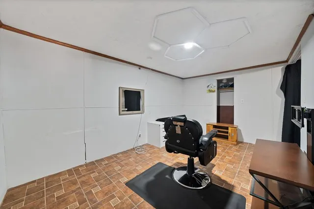 a room with furniture a rug and gym equipment