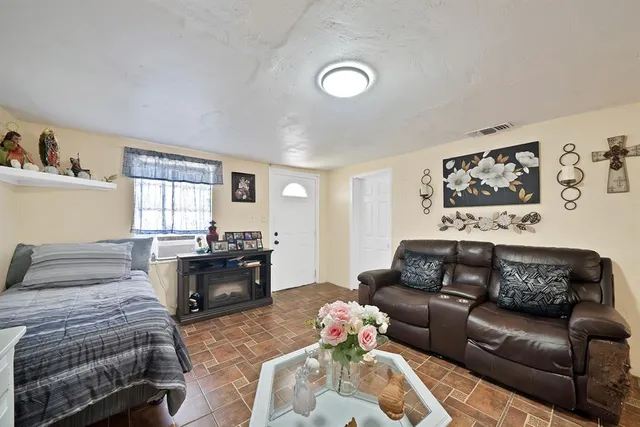 a bedroom with a bed couch and window