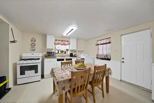a dining room with furniture and window