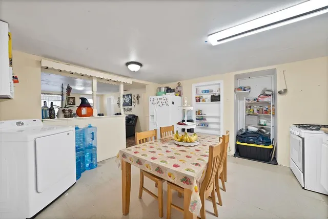 a kitchen that has a table and chairs in it