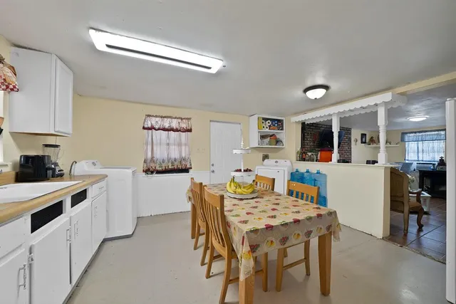 a kitchen that has a table and chairs in it
