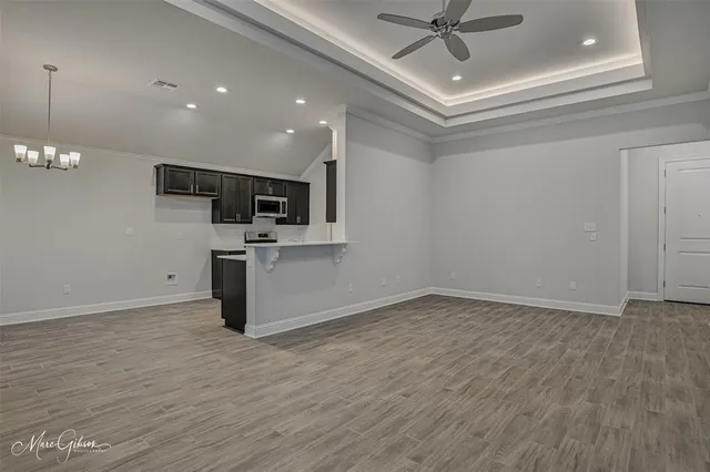 a view of kitchen with sink microwave and stove