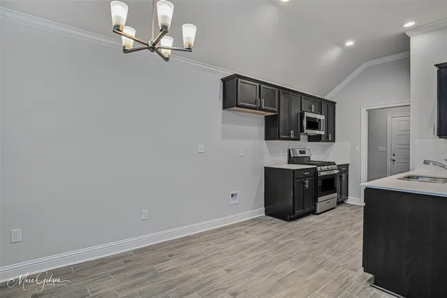a view of kitchen with sink microwave refrigerator and stove