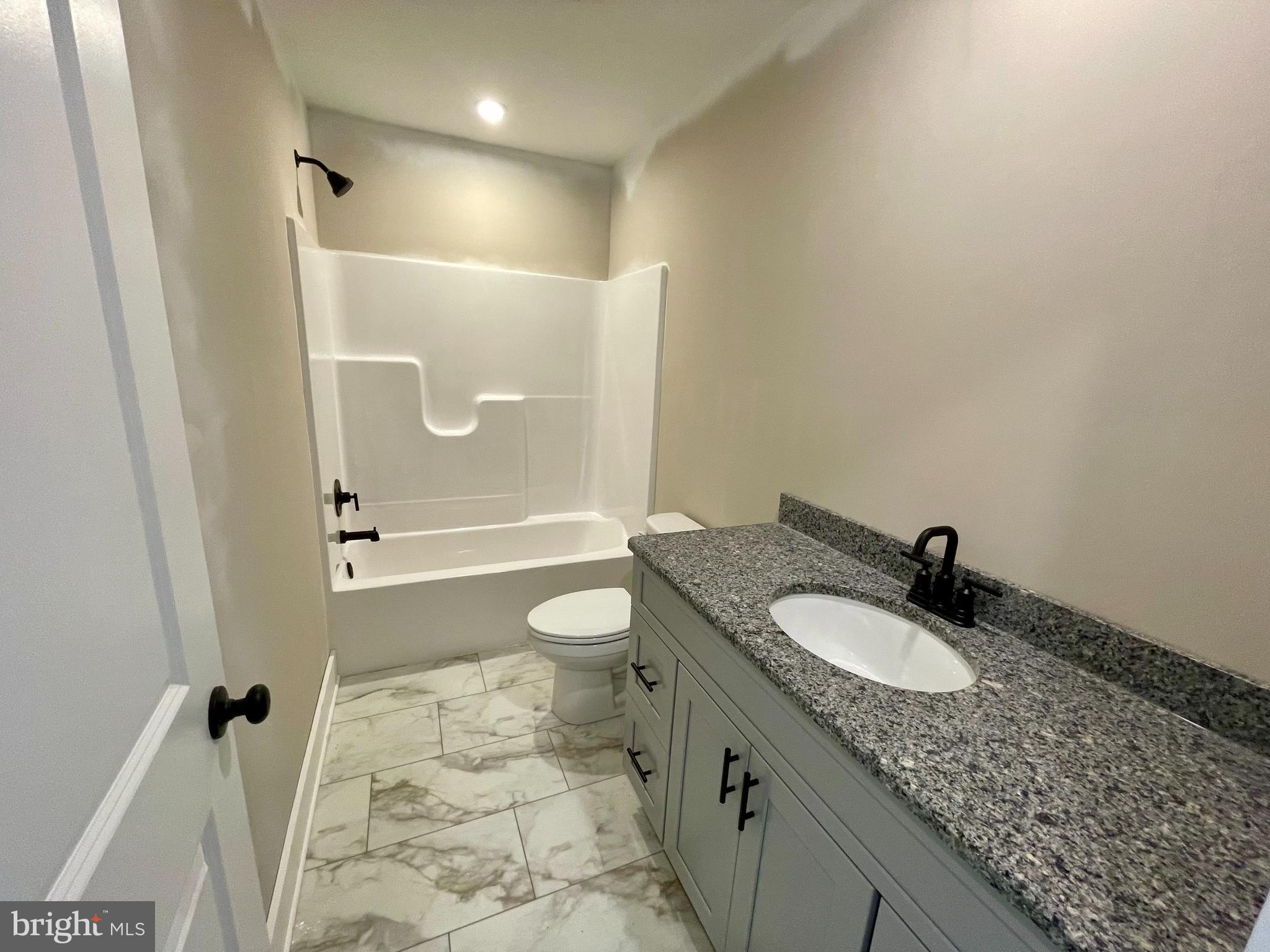 180 Stone Ridge Albrightsville, PA 18210 - Photo 14 of 23 a bathroom with a granite countertop sink a mirror and a toilet