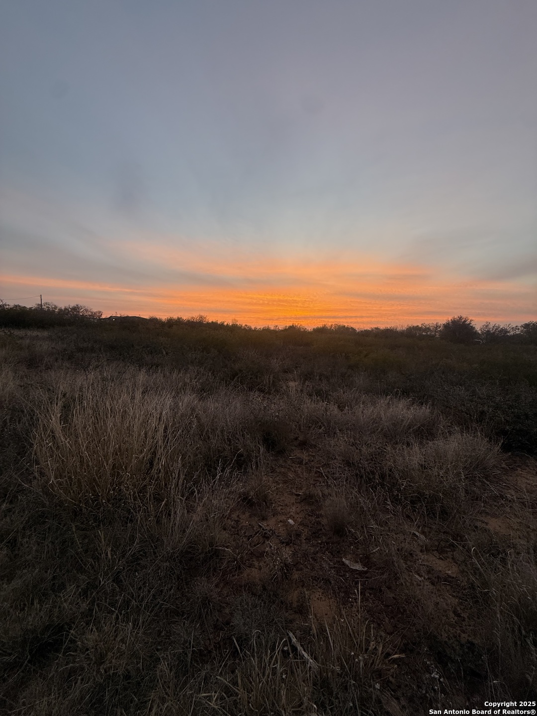 161 County Road 2665 Devine, TX 78016 - Photo 3 of 4 a view of a sunset