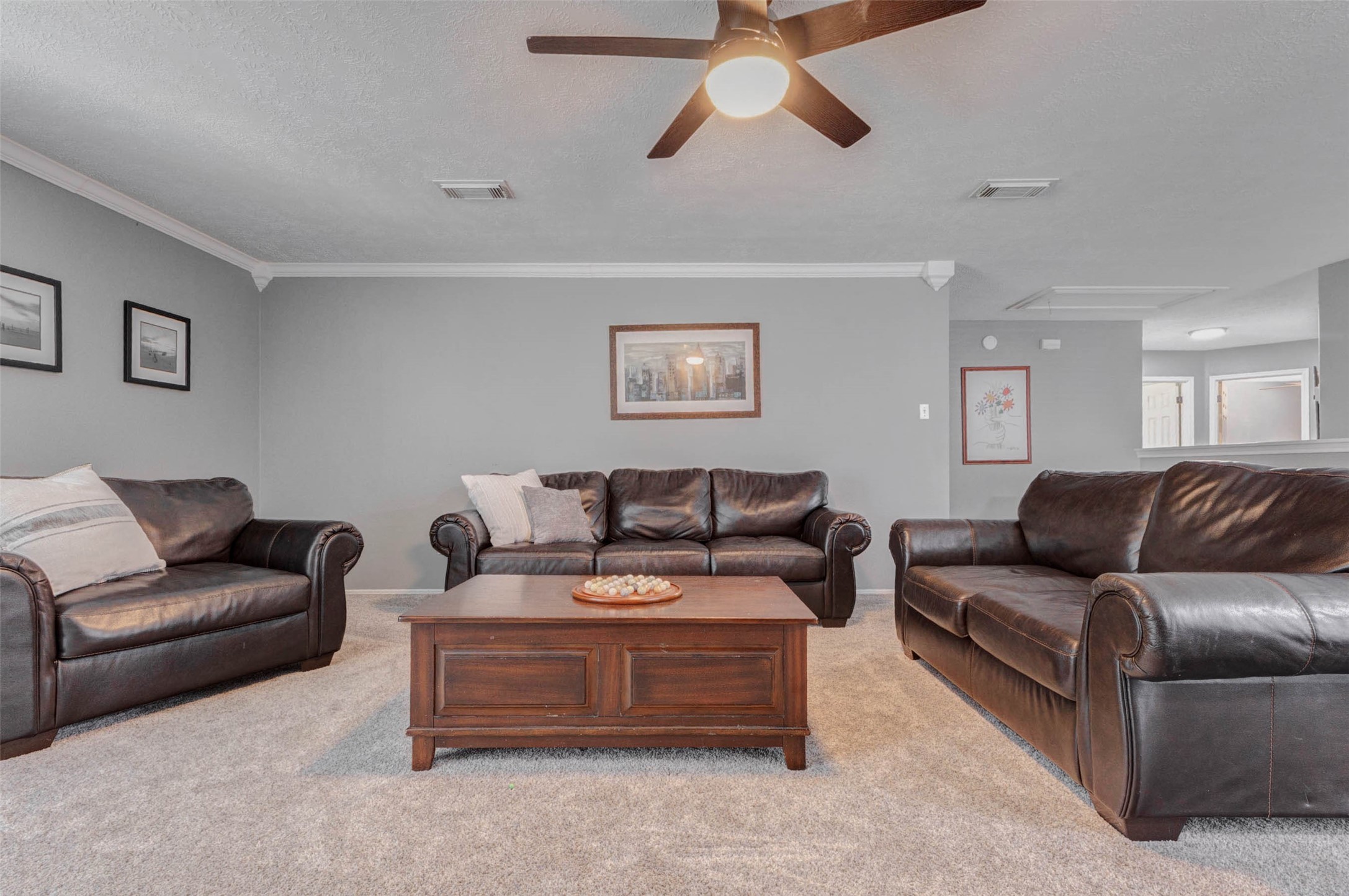 9215 Landry Boulevard Spring, TX 77379 - Photo 22 of 42 The expansive upstairs game room offers endless possibilities for entertaining, movie nights, or a secondary living area and features neutral paint, crown molding, Dream Weaver Rustic Retreat II Laurel carpet with upgraded memory foam pad throughout the upstairs, and a ceiling fan for added comfort.