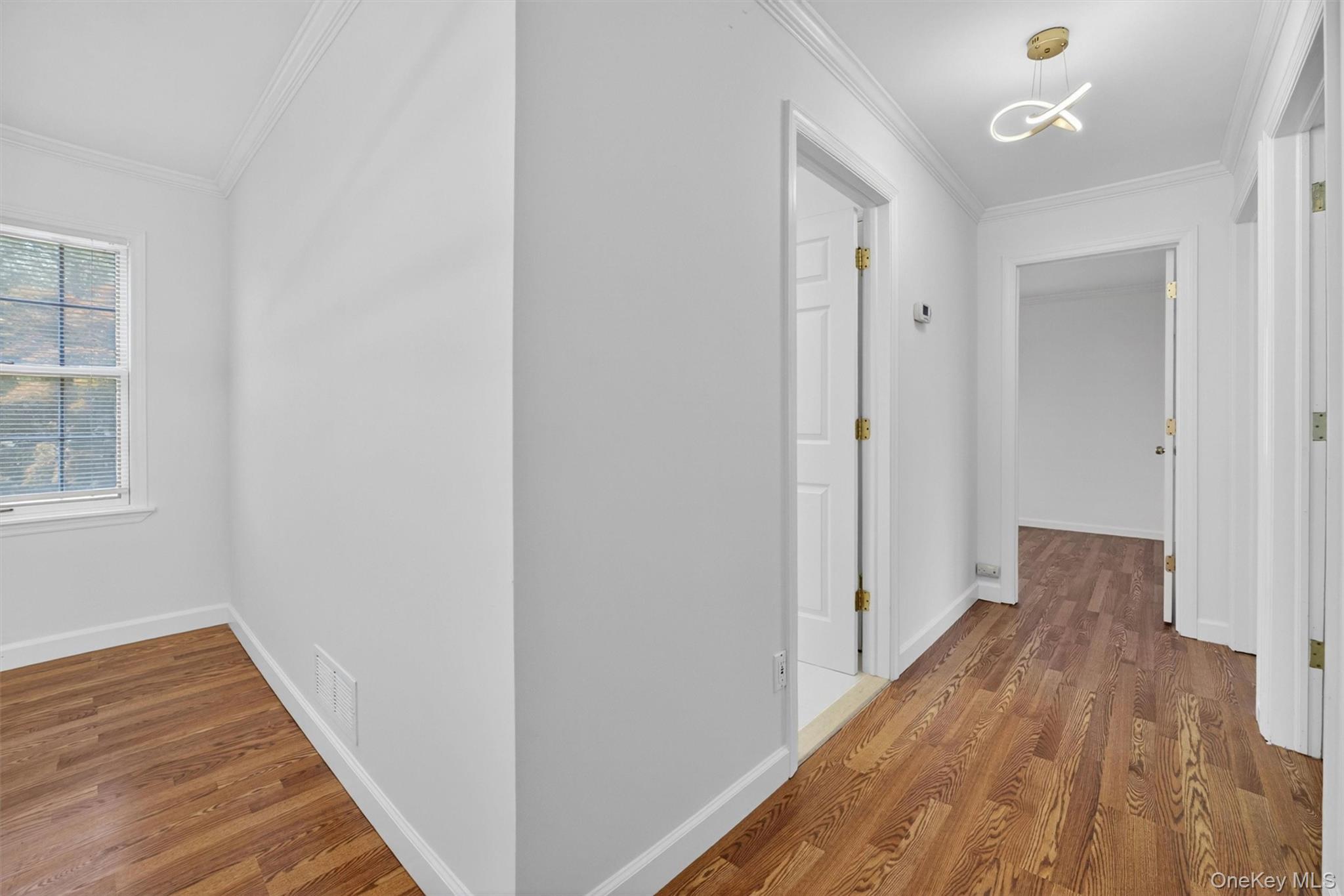 263 Croydon Road Yonkers, NY 10710 - Photo 20 of 43 a view of a hallway with wooden floor and a window