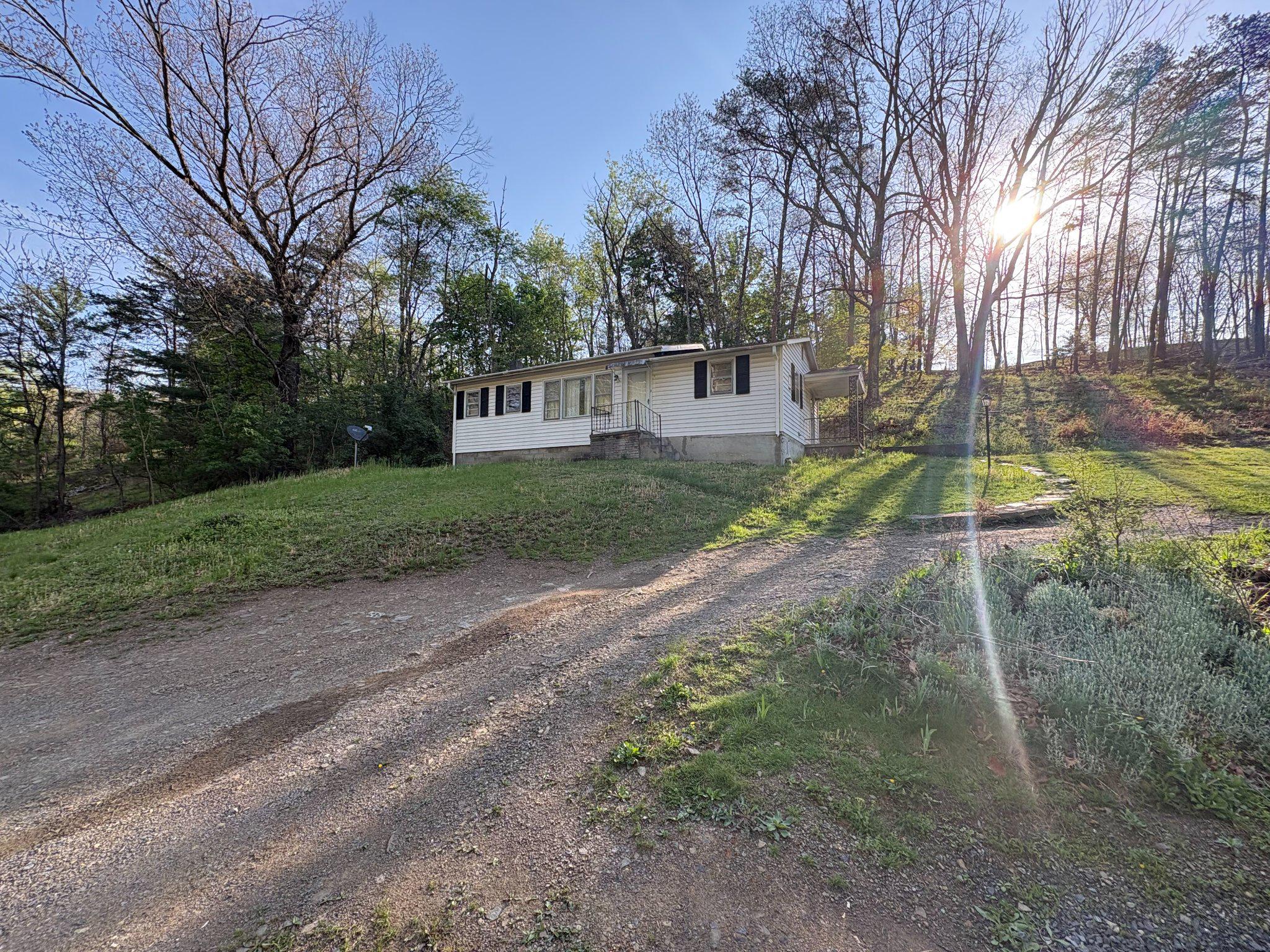 119 Radio Station Road Berkeley Springs, WV 25411 - Photo 2 of 14 Charming hillside retreat with sunlight glow.