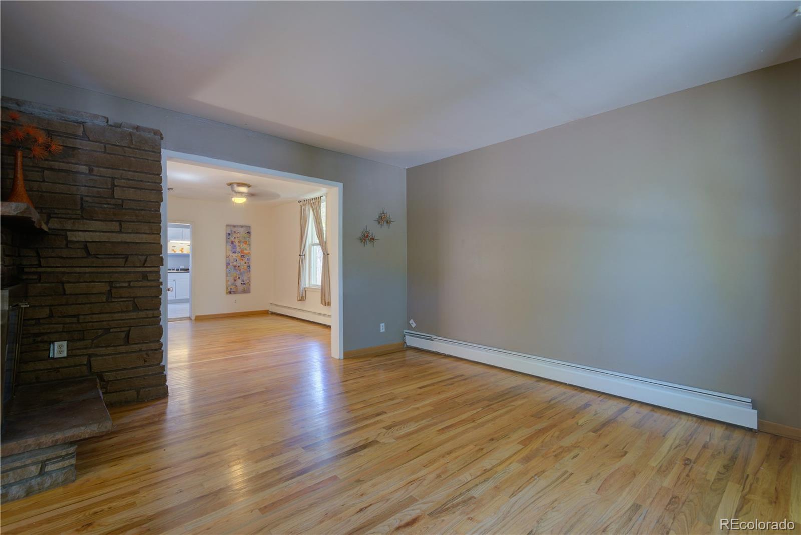 2537 Ames Street Edgewater, CO 80214 - Photo 21 of 38 a view of an empty room with wooden floor and a window