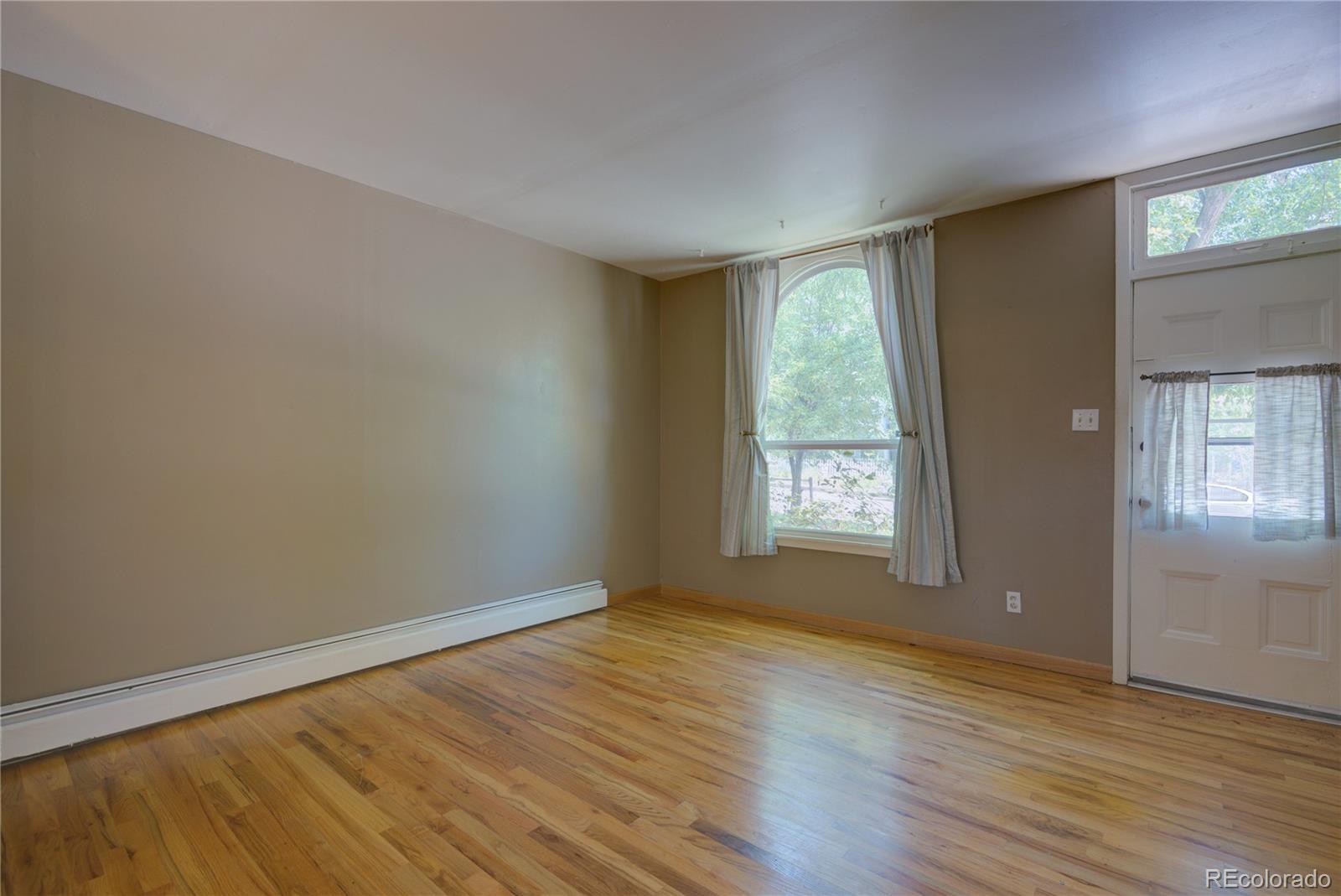 2537 Ames Street Edgewater, CO 80214 - Photo 23 of 38 a view of an empty room with wooden floor and a window