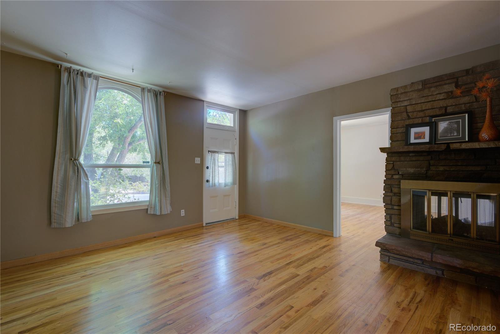 2537 Ames Street Edgewater, CO 80214 - Photo 24 of 38 a view of an empty room with wooden floor and a window