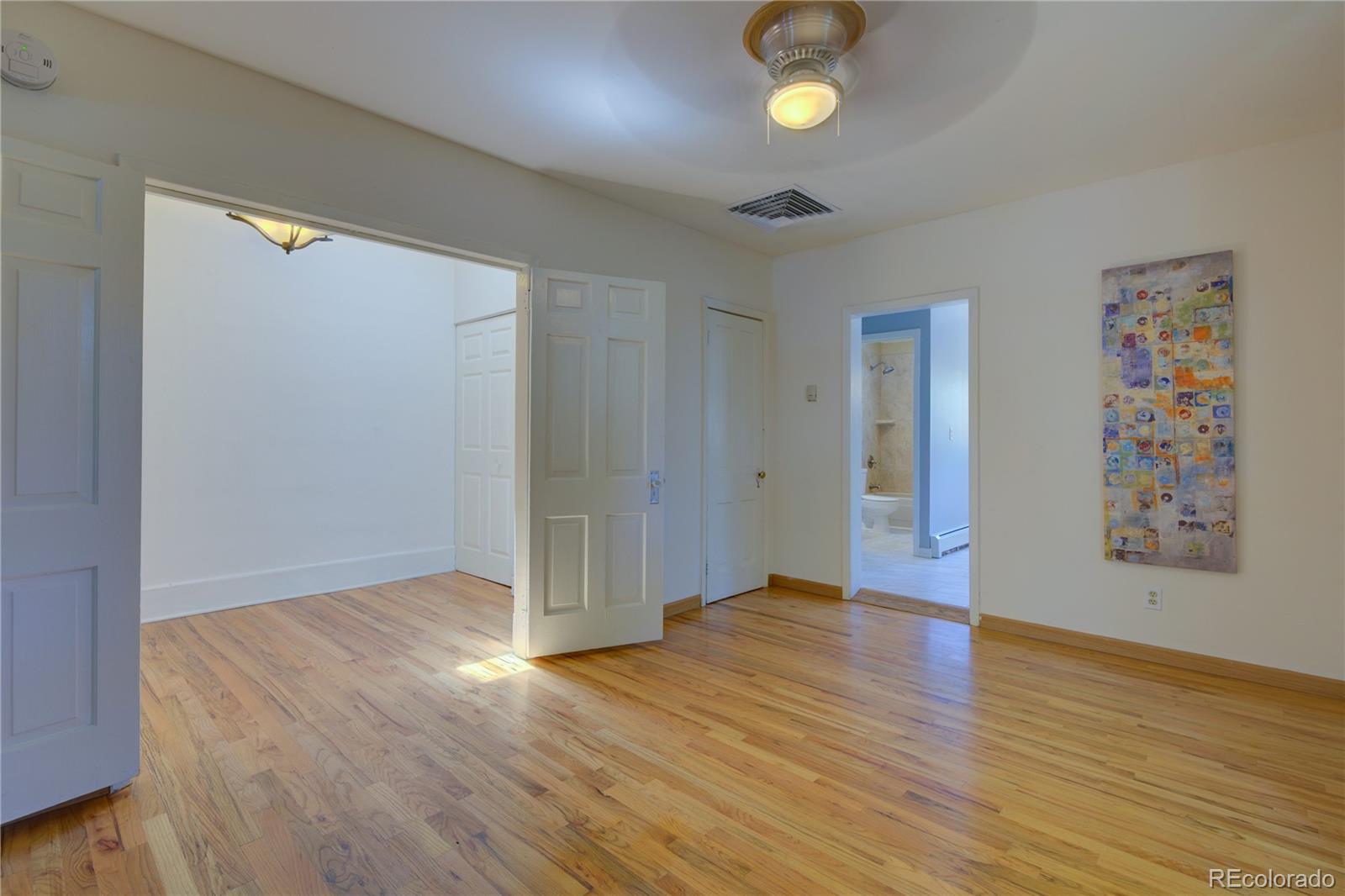 2537 Ames Street Edgewater, CO 80214 - Photo 30 of 38 an empty room with wooden floor and windows