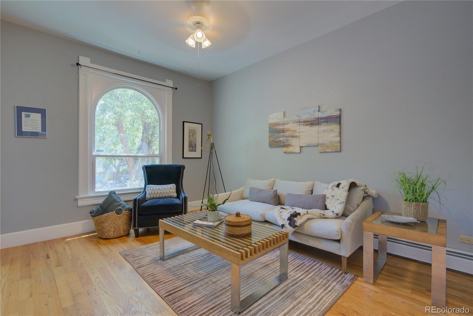 2537 Ames Street Edgewater, CO 80214 - Photo 3 of 38 a living room with furniture fireplace and a large window