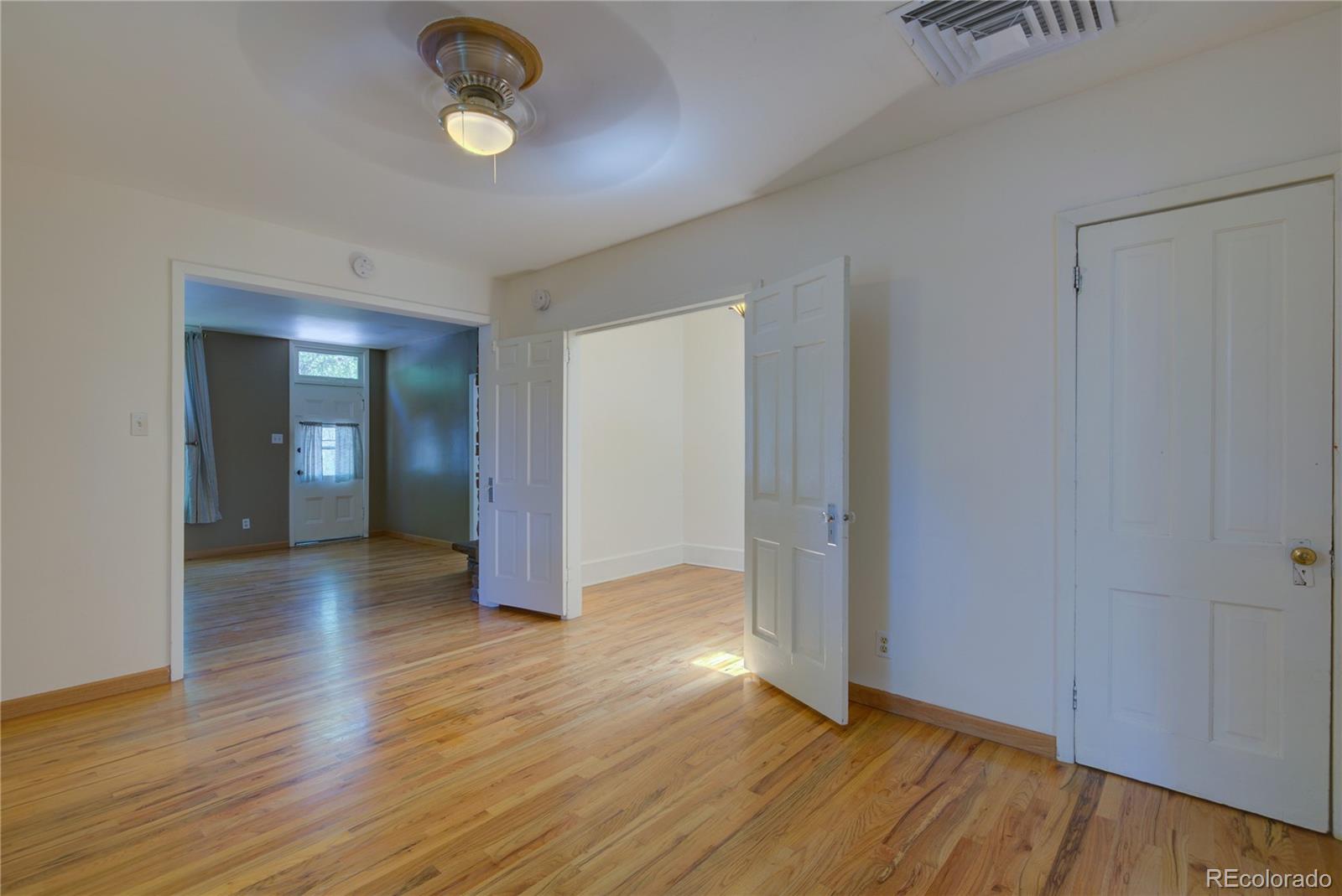 2537 Ames Street Edgewater, CO 80214 - Photo 31 of 38 an empty room with wooden floor and windows