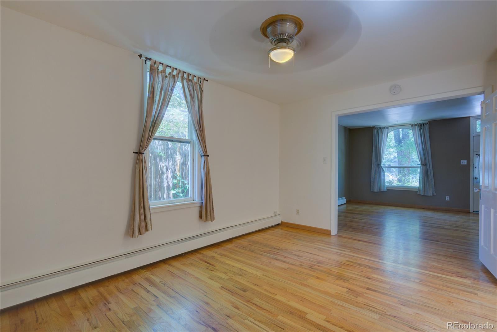 2537 Ames Street Edgewater, CO 80214 - Photo 32 of 38 an empty room with wooden floor and windows