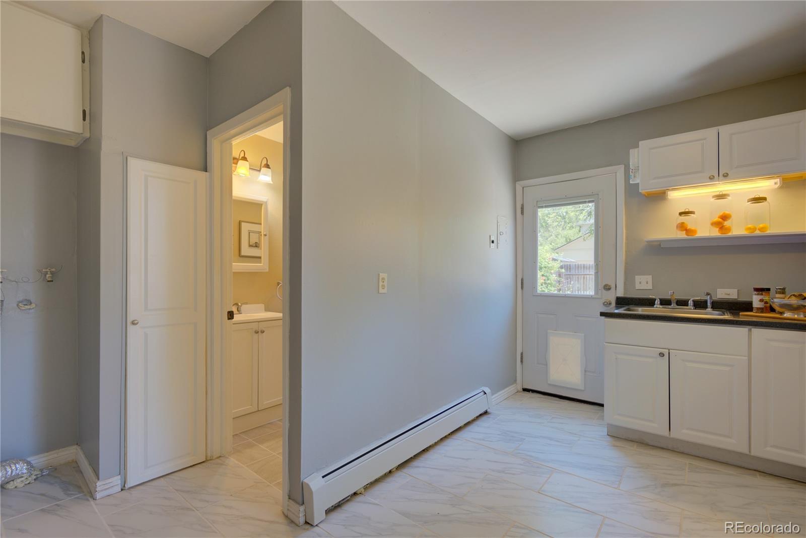 2537 Ames Street Edgewater, CO 80214 - Photo 35 of 38 a kitchen with stainless steel appliances a stove top oven and sink